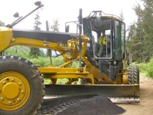 Kirk operating a big yellow machine in Mineral King photo by Michael Botkin