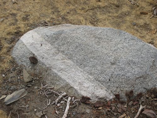 Bigger granite rock with white (marble? limestone?) stripe