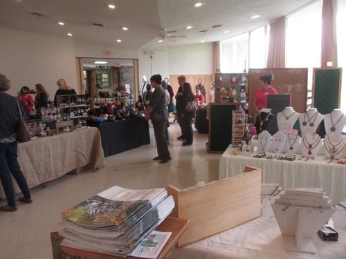 Before the show, some of the vendors check out each other's booths. 